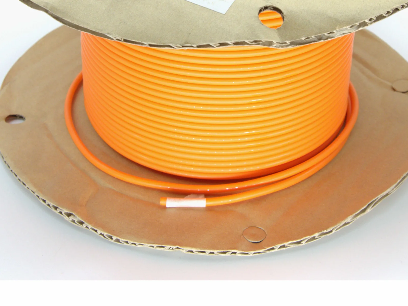 Orange round belt supplied on a neutral cardboard reel